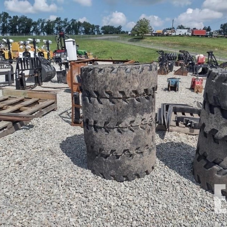 (4) 12-16.5 SOLID TIRES W/RIMS