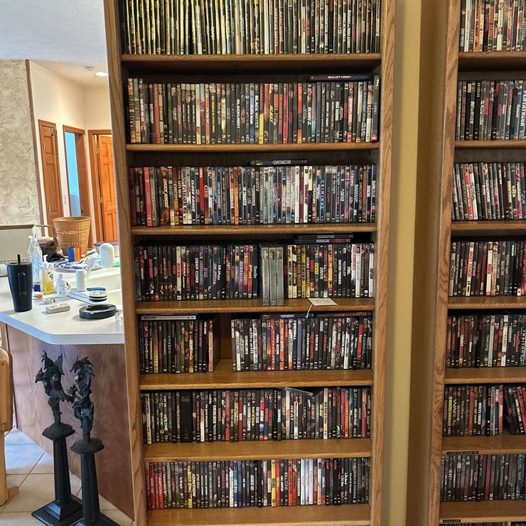 Bookshelf and DVD’s alphabetically organized DVDs letter A through letter M. 84” T x 33” W