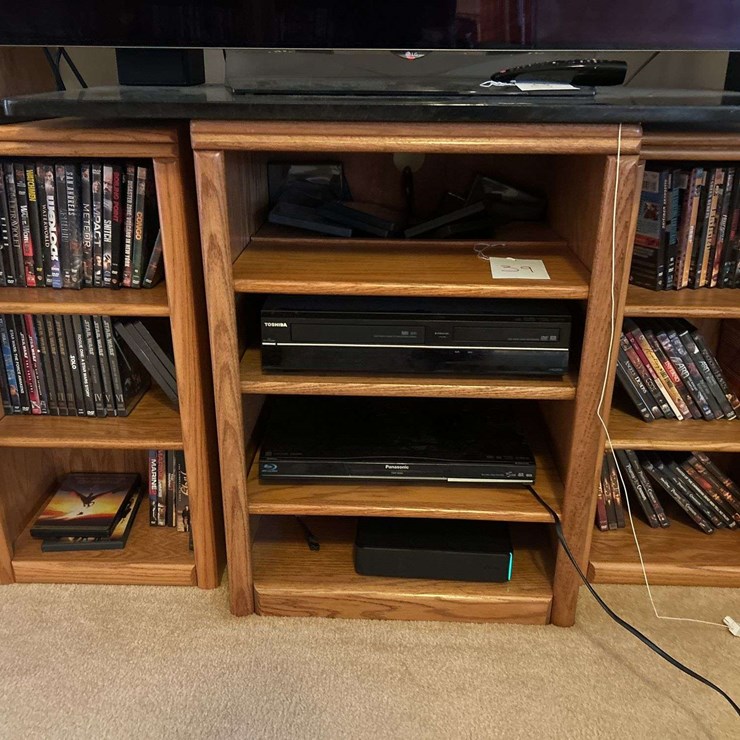 TV stand with Toshiba DVD/VCR player, panasonic blu-ray player, and DVDs
