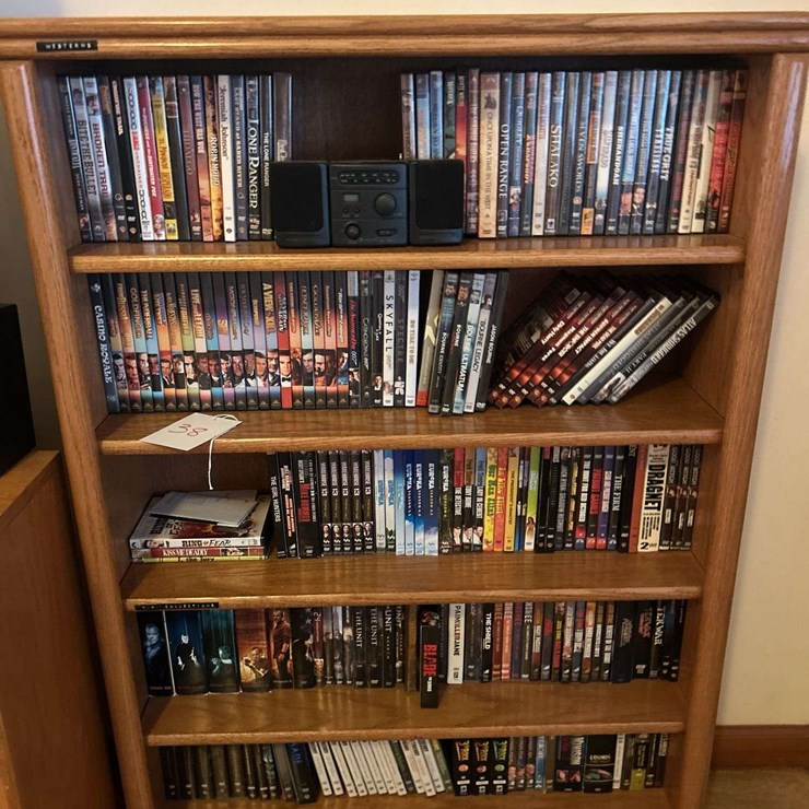 Bookshelf and DVD’s, Small Boombox - (assorted DVD's) The shelf is 82” tall by 36” wide.