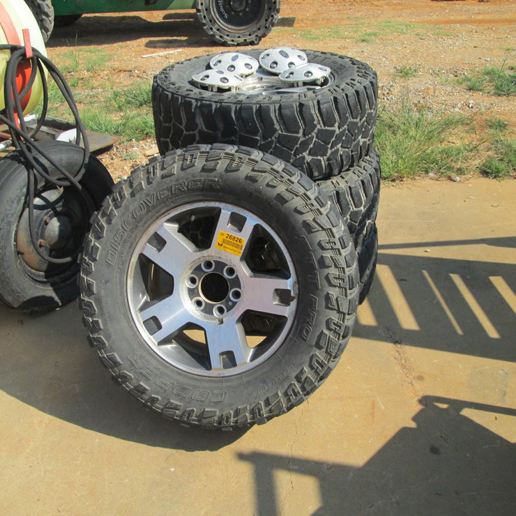#52 • #26826 • Lot of (4) Cooper 285/65R18 Tires & Ford Wheels