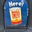 1001---shell-x-100-'here!'-tombstone-tin-sign---30"-x-42"---double-sided-image-1