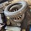 old-car-parts-including:-3-wheels-on-wood-spokes,-36x6-tire,-headlights,-windshield-image-1