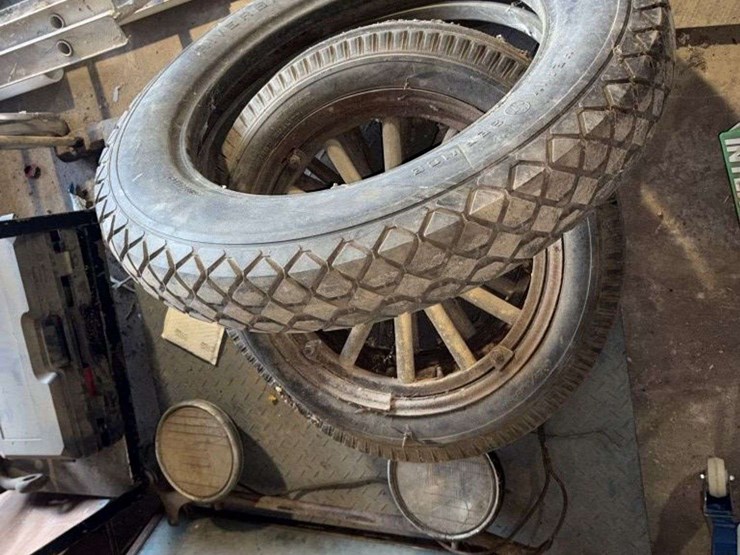 old-car-parts-including:-3-wheels-on-wood-spokes,-36x6-tire,-headlights,-windshield-image-1
