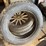 old-car-parts-including:-3-wheels-on-wood-spokes,-36x6-tire,-headlights,-windshield-image-2