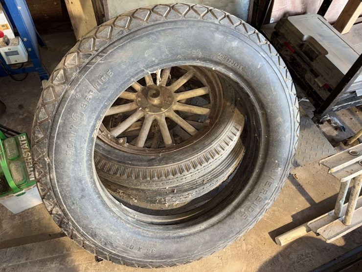 old-car-parts-including:-3-wheels-on-wood-spokes,-36x6-tire,-headlights,-windshield-image-2