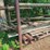outdoor-metal-storage-rack,-3-shelves-with-assorted-lumber-&-stakes,-pipe-image-1