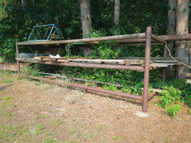 17'-x-6'-x-5'-outdoor-pipe-storage-rack-with-3-shelves,-with-assorted-lumber,-stakes,-and-large-26'-x-6"-pipe-(blue-metal-horses-not-included)-image-1