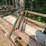 outdoor-metal-storage-rack,-3-shelves-with-assorted-lumber-&-stakes,-pipe-image-3
