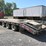 interstate-25-ton,-triaxle-tag-trailer,-24'-deck,-5'-beavertail,-ramps.-image-1