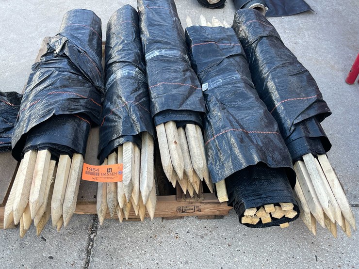 #1964-•-wood-stakes-and-tarp-fencing-image-1