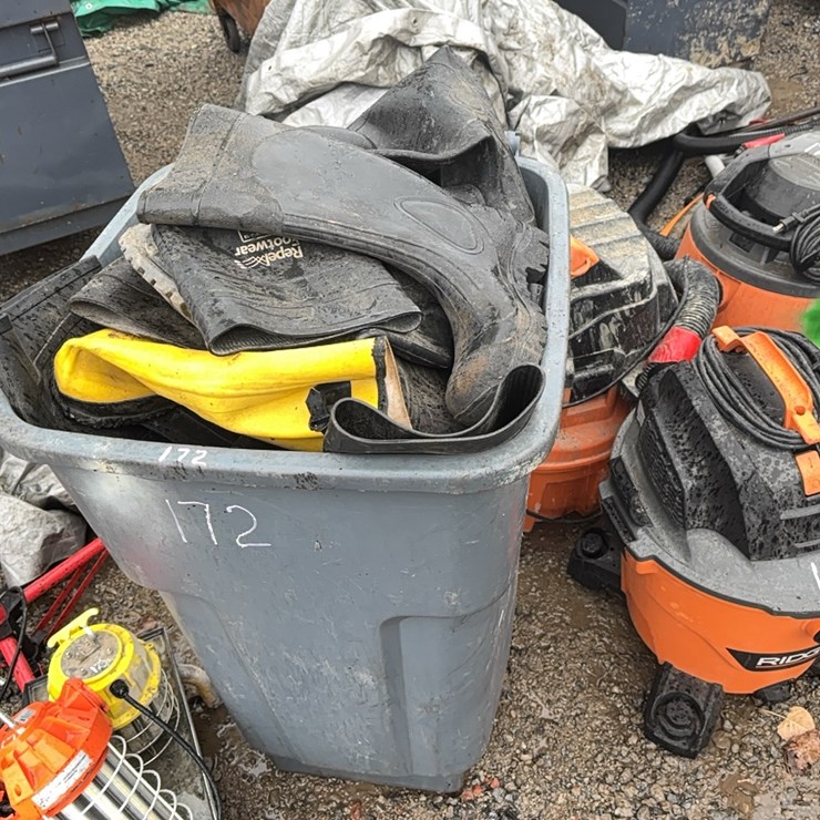 TRASH BARREL FULL OF RUBBER BOOTS SUPPORT EQUIPMENT