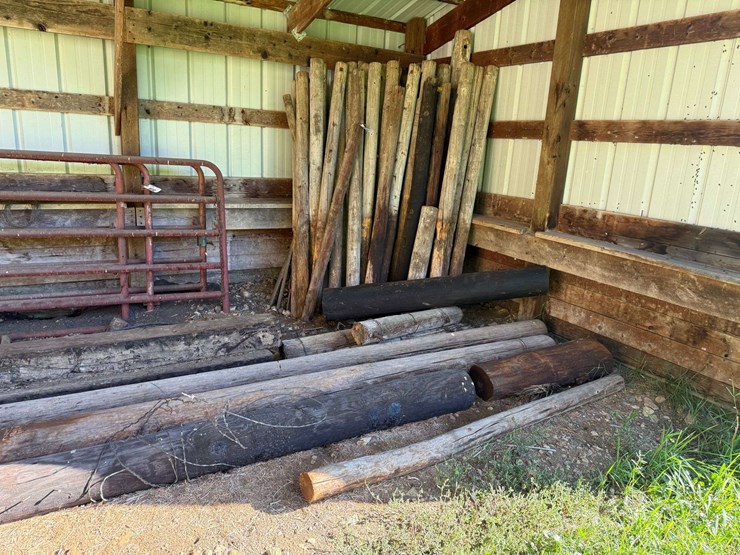 large-assortment-of-wood-fence-posts,-railroad-ties,-rebar,-wire-image-1