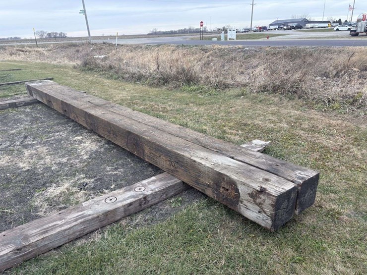 (2)-12”x12”x26’-approx-creosote-treated-wood-beams,-a-image-1