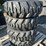 (4)-unused-10-16.5-tires-on-bobcat-wheels-image-1