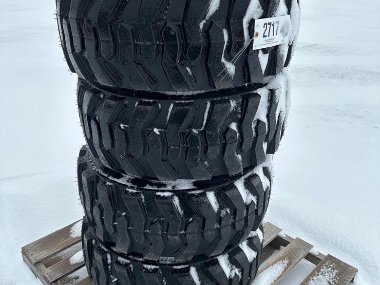 2717---(4)---new-12x16.5-nhs-tires-on-bobcat-style-8-lug-rims-image-1