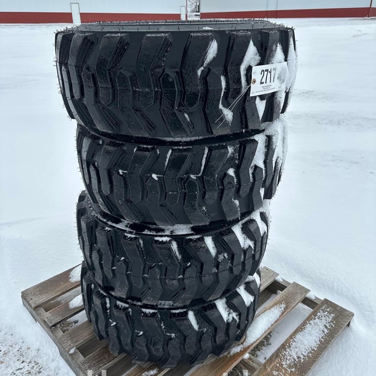 2717 - (4) - NEW 12x16.5 NHS TIRES ON BOBCAT STYLE 8 LUG RIMS