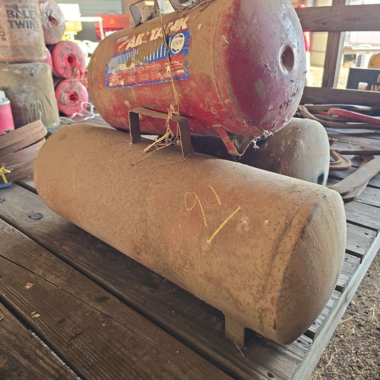 3 various sized metal air tanks