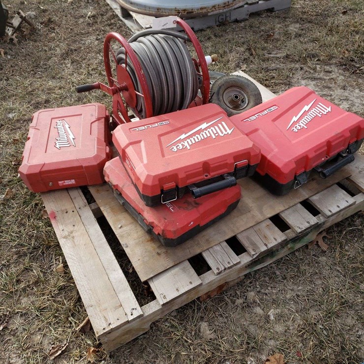 4 Milwaukee Hard Cases and Garden Hose Reel, and 2 4.10/3.50 tires