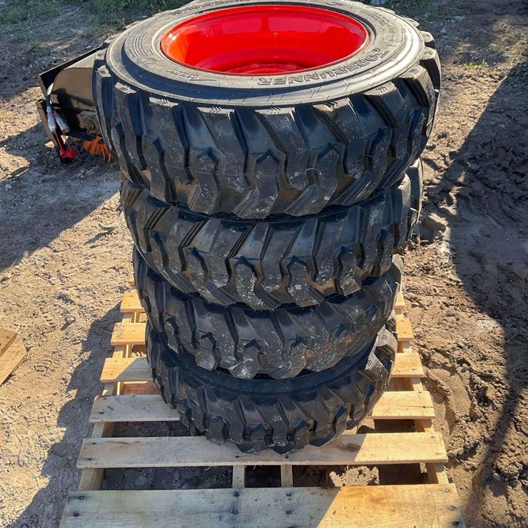 Set 4 - 10-16.5 tires on wheels for bobcat