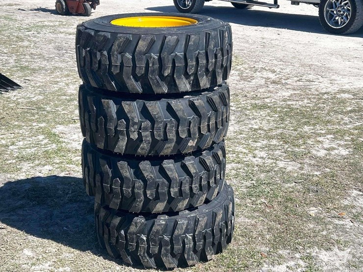 lot-of-4-12-16.5nhs-skid-steer-wheels-and-tires-image-1