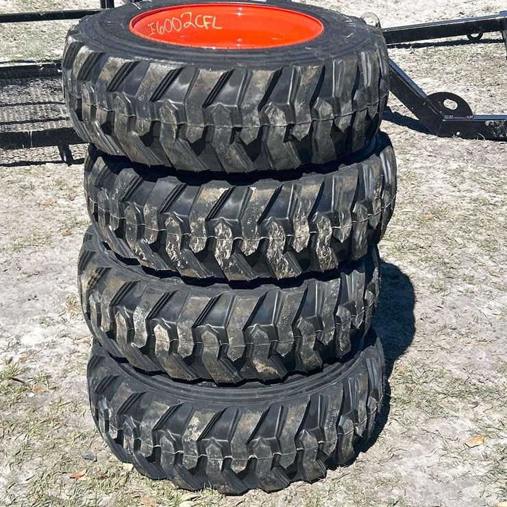Lot of 4 10-16.5NHS Skid Steer Wheels and Tires