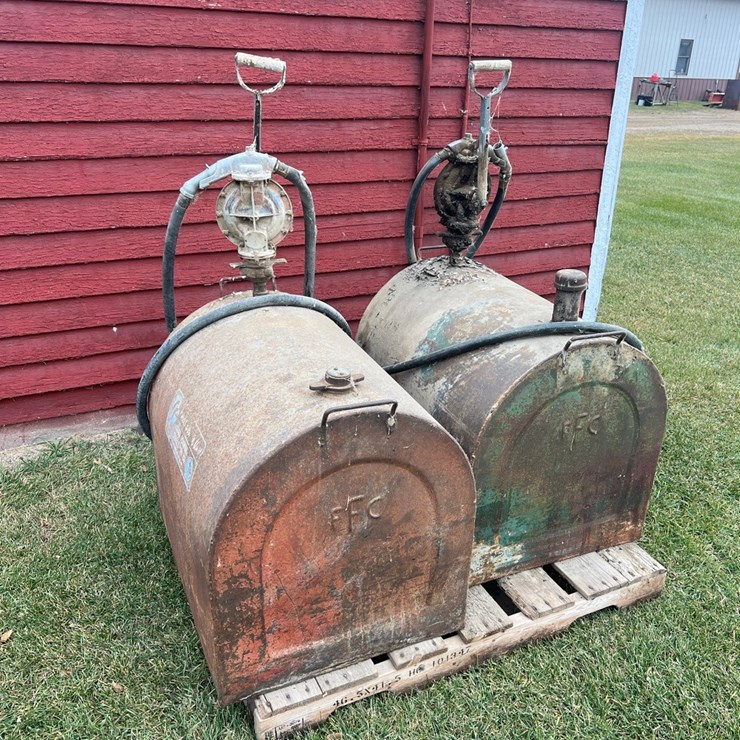 Lot 39. 70 gallon service tank with hand pump, stored inside. (bid is for the red tank)
