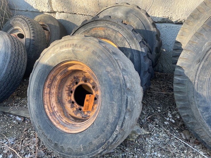#6031-•-(3)-skidsteer-tires-on-8-bolt-rims-image-1