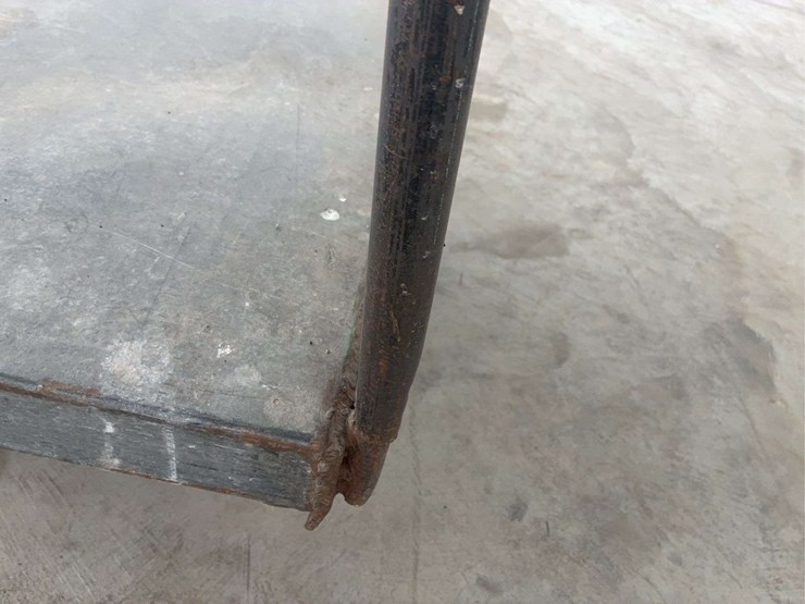 heavy-duty-steel-platform-cart-with-dual-handles-and-four-wheels-image-7