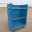 blue-polyethylene-rolling-laundry-cart-with-metal-shelves-image-1