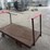 heavy-duty-steel-platform-cart-with-dual-handles-and-cast-iron-wheels-image-2