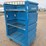 blue-polyethylene-rolling-laundry-cart-with-metal-shelves-image-2