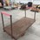 heavy-duty-steel-platform-cart-with-dual-handles-and-cast-iron-wheels-image-1