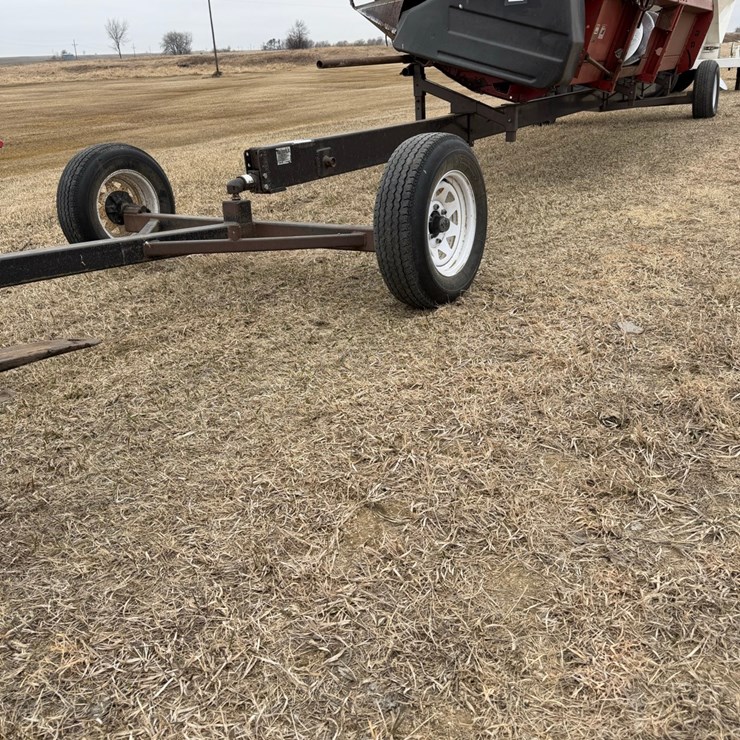 Seller #10.  Straight header transport, adjustable 20’ – 30’, works great, has a pivot trailer in front of the hitch, was made in Bisbee at Vulcan Ironworks