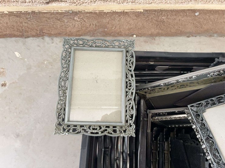 milk-crate-containing-a-multitude-of-metal-frame-picture-frames-image-4