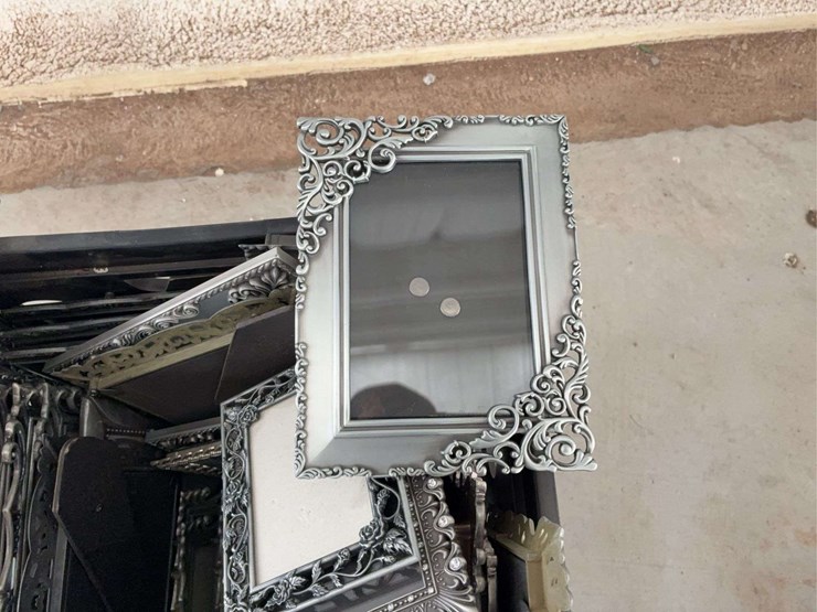 milk-crate-containing-a-multitude-of-metal-frame-picture-frames-image-5