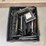 milk-crate-containing-a-multitude-of-metal-frame-picture-frames-image-2