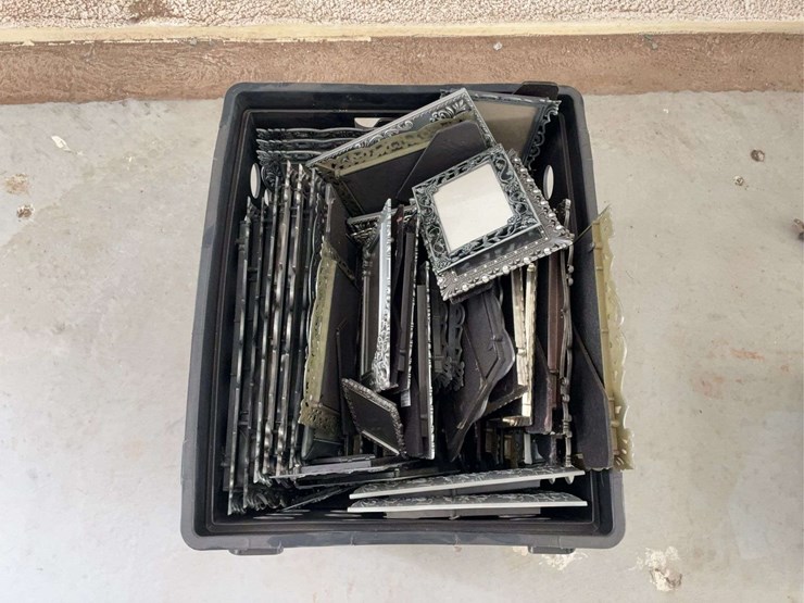 milk-crate-containing-a-multitude-of-metal-frame-picture-frames-image-2