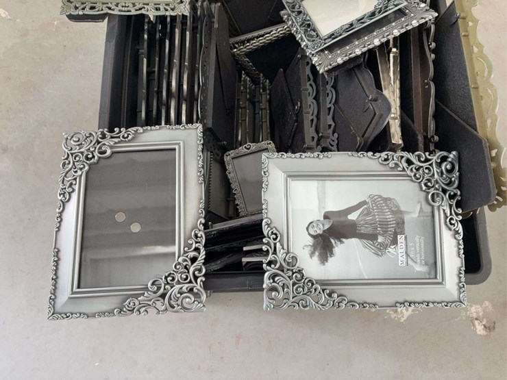 milk-crate-containing-a-multitude-of-metal-frame-picture-frames-image-6