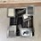 milk-crate-containing-a-multitude-of-metal-frame-picture-frames-image-3