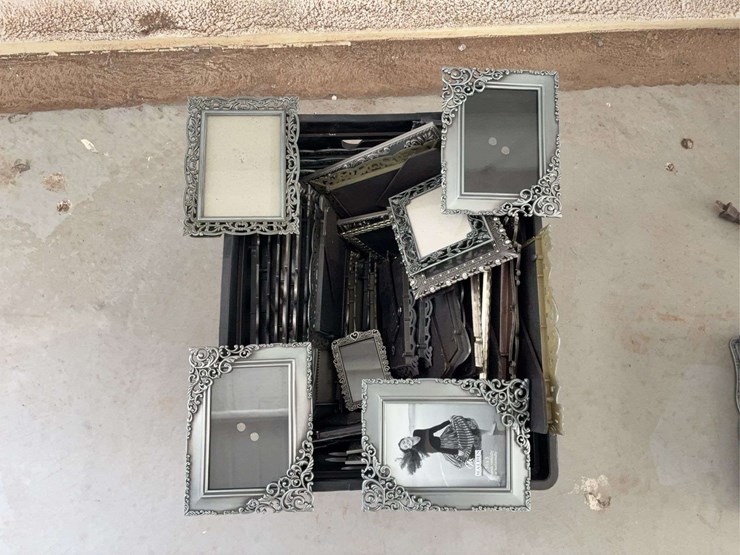 milk-crate-containing-a-multitude-of-metal-frame-picture-frames-image-3