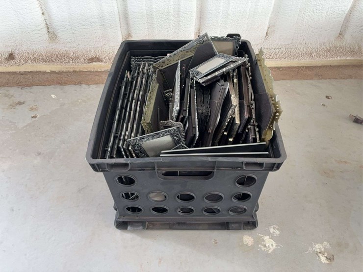 milk-crate-containing-a-multitude-of-metal-frame-picture-frames-image-1
