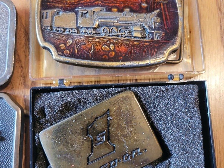 collection-of-four-assorted-metal-belt-buckles-including-snap-on-and-adm-transportation-image-4