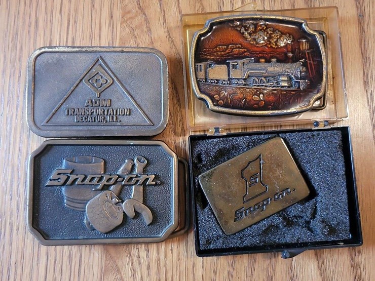 collection-of-four-assorted-metal-belt-buckles-including-snap-on-and-adm-transportation-image-1