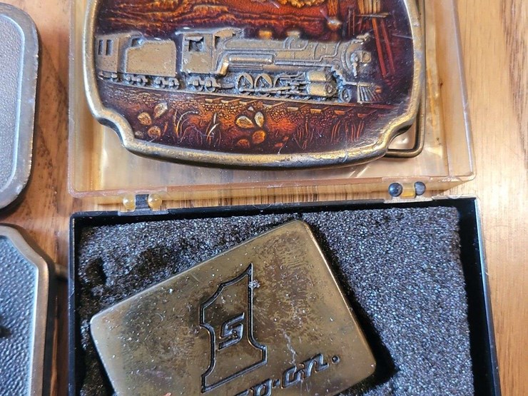 collection-of-four-assorted-metal-belt-buckles-including-snap-on-and-adm-transportation-image-3