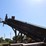 approx-250'-barn-sweep-conveyor-w/-patz-style-chain-w/-40'-incline-section-w/heavy-duty-hydraulic-drive-w/-the-rest-of-the-chain-riding-on-concrete-base-w/-idler-rolls-image-2