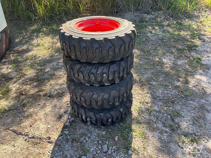 set-of-4-unused-10-16.5n.h.s.-forerunner-skid-steer-wheels-and-tires-image-1