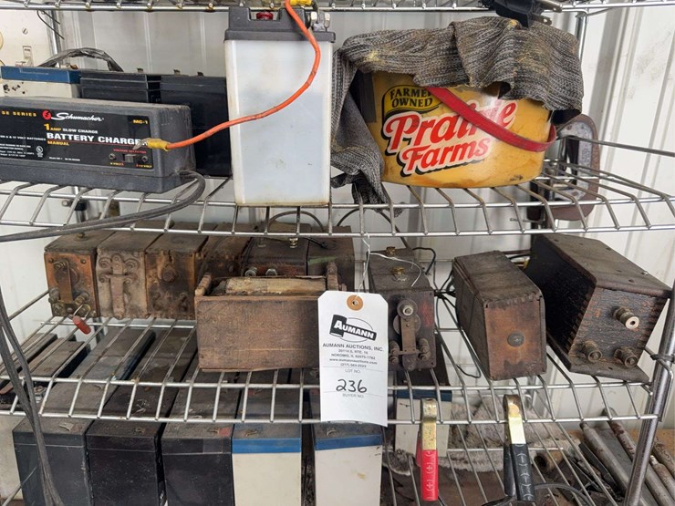 assorted-garage-shelf-contents-including-automotive-fluids,-batteries,-charger,-and-accessories-image-4