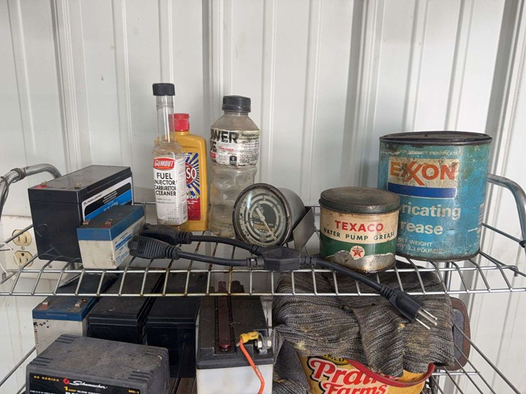 assorted-garage-shelf-contents-including-automotive-fluids,-batteries,-charger,-and-accessories-image-2