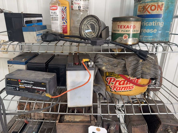 assorted-garage-shelf-contents-including-automotive-fluids,-batteries,-charger,-and-accessories-image-3